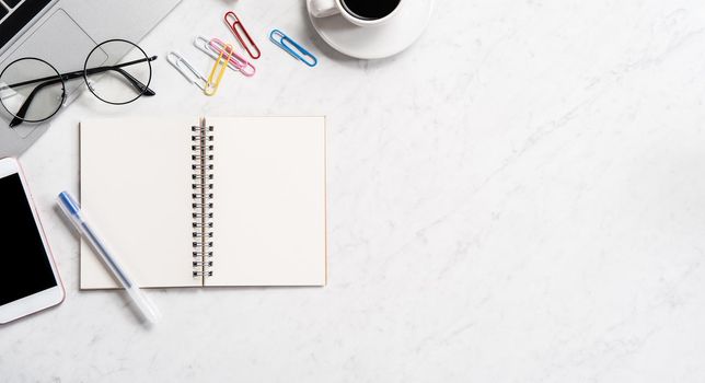 Stylized marble office working desk with smartphone, laptop, glasses and coffee, workspace design, mock up, topview, flatlay, copyspace, closeup