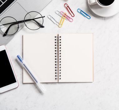 Stylized marble office working desk with smartphone, laptop, glasses and coffee, workspace design, mock up, topview, flatlay, copyspace, closeup