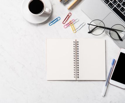 Stylized marble office working desk with smartphone, laptop, glasses and coffee, workspace design, mock up, topview, flatlay, copyspace, closeup