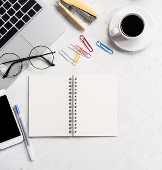 Stylized marble office working desk with smartphone, laptop, glasses and coffee, workspace design, mock up, topview, flatlay, copyspace, closeup