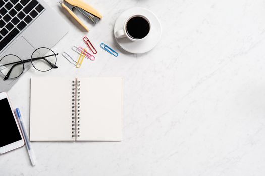 Stylized marble office working desk with smartphone, laptop, glasses and coffee, workspace design, mock up, topview, flatlay, copyspace, closeup