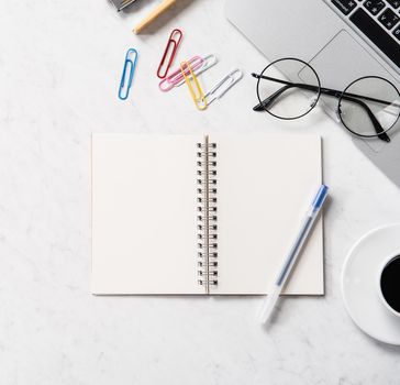 Stylized marble office working desk with smartphone, laptop, glasses and coffee, workspace design, mock up, topview, flatlay, copyspace, closeup