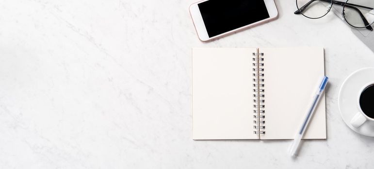 Stylized marble office working desk with smartphone, laptop, glasses and coffee, workspace design, mock up, topview, flatlay, copyspace, closeup