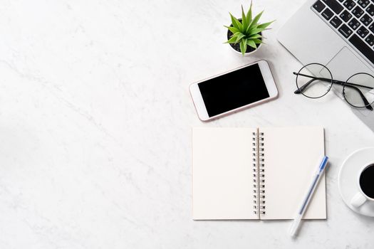 Stylized marble office working desk with smartphone, laptop, glasses and coffee, workspace design, mock up, topview, flatlay, copyspace, closeup