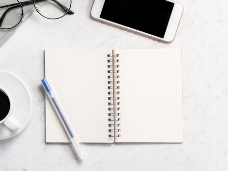 Stylized marble office working desk with smartphone, laptop, glasses and coffee, workspace design, mock up, topview, flatlay, copyspace, closeup