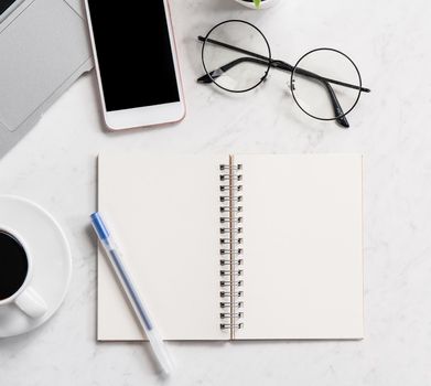 Stylized marble office working desk with smartphone, laptop, glasses and coffee, workspace design, mock up, topview, flatlay, copyspace, closeup