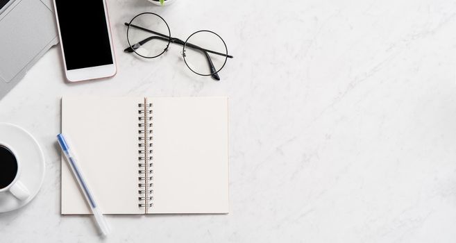 Stylized marble office working desk with smartphone, laptop, glasses and coffee, workspace design, mock up, topview, flatlay, copyspace, closeup