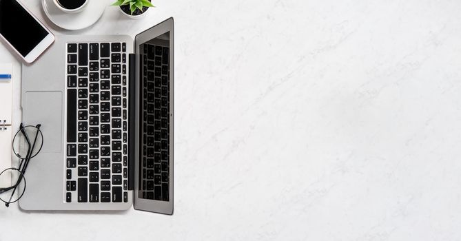 Stylized marble office working desk with smartphone, laptop, glasses and coffee, workspace design, mock up, topview, flatlay, copyspace, closeup