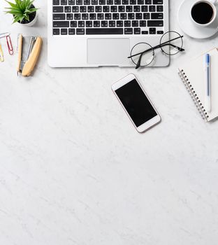 Stylized marble office working desk with smartphone, laptop, glasses and coffee, workspace design, mock up, topview, flatlay, copyspace, closeup