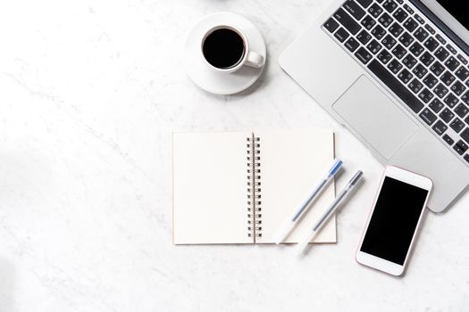 Stylized marble office working desk with smartphone, laptop, glasses and coffee, workspace design, mock up, topview, flatlay, copyspace, closeup