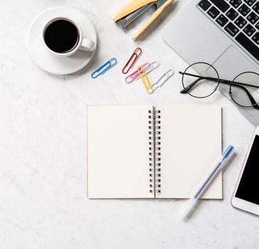 Stylized marble office working desk with smartphone, laptop, glasses and coffee, workspace design, mock up, topview, flatlay, copyspace, closeup