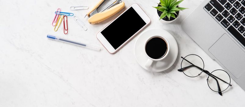 Stylized marble office working desk with smartphone, laptop, glasses and coffee, workspace design, mock up, topview, flatlay, copyspace, closeup