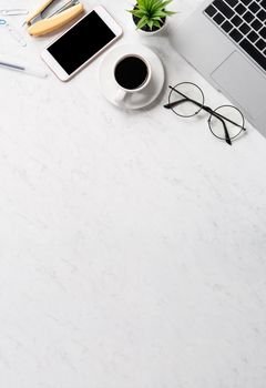 Stylized marble office working desk with smartphone, laptop, glasses and coffee, workspace design, mock up, topview, flatlay, copyspace, closeup