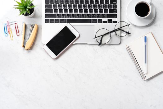 Stylized marble office working desk with smartphone, laptop, glasses and coffee, workspace design, mock up, topview, flatlay, copyspace, closeup