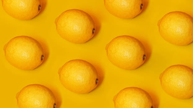 Food pattern with lemons on yellow paper background. Top view. Summer concept. Vegan and vegetarian diet.