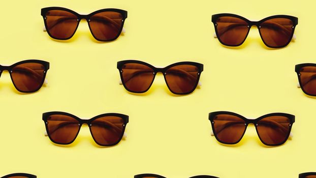 Sunglasses rows pattern on yellow background with the shadows