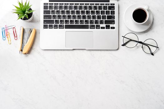 Stylized marble office working desk with smartphone, laptop, glasses and coffee, workspace design, mock up, topview, flatlay, copyspace, closeup