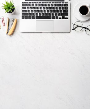 Stylized marble office working desk with smartphone, laptop, glasses and coffee, workspace design, mock up, topview, flatlay, copyspace, closeup