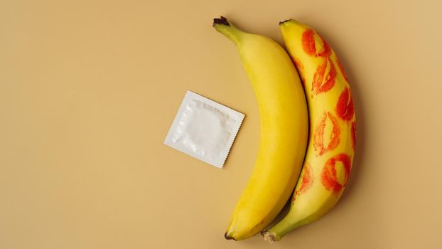 Condoms and two bananas with traces of red lipstick, concept of contraceptives and the prevention of venereal diseases.