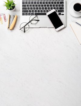 Stylized marble office working desk with smartphone, laptop, glasses and coffee, workspace design, mock up, topview, flatlay, copyspace, closeup