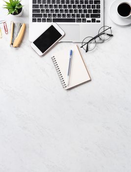 Stylized marble office working desk with smartphone, laptop, glasses and coffee, workspace design, mock up, topview, flatlay, copyspace, closeup