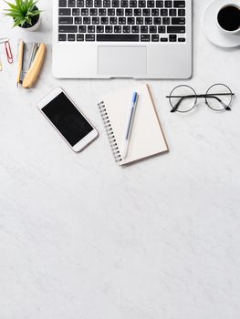 Stylized marble office working desk with smartphone, laptop, glasses and coffee, workspace design, mock up, topview, flatlay, copyspace, closeup