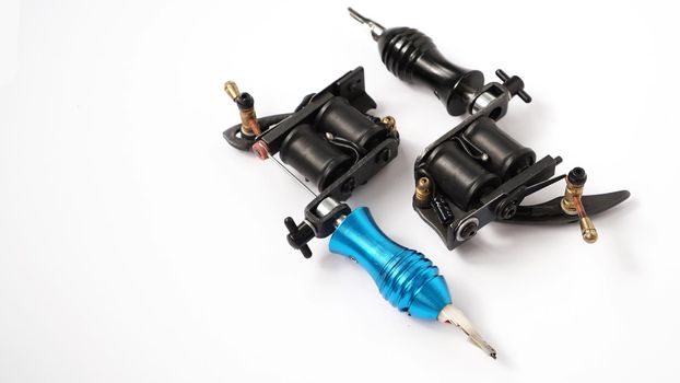 Two tattoo machines on a white background - tattoo industry -space for text