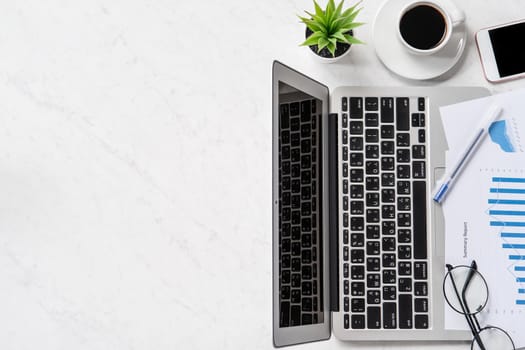 A woman is doing a online payment or shopping, mock up credit card and mobile phone on office desk isolated on beautiful fashion marble background, topview, flatlay, copyspace.