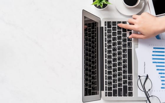 A woman is doing a online payment or shopping, mock up credit card and mobile phone on office desk isolated on beautiful fashion marble background, topview, flatlay, copyspace.