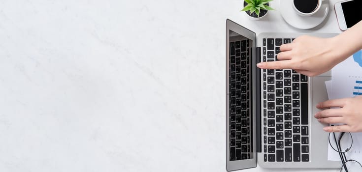 A woman is doing a online payment or shopping, mock up credit card and mobile phone on office desk isolated on beautiful fashion marble background, topview, flatlay, copyspace.