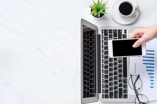 A woman is doing a online payment or shopping, mock up credit card and mobile phone on office desk isolated on beautiful fashion marble background, topview, flatlay, copyspace.