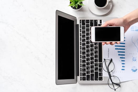 A woman is doing a online payment or shopping, mock up credit card and mobile phone on office desk isolated on beautiful fashion marble background, topview, flatlay, copyspace.