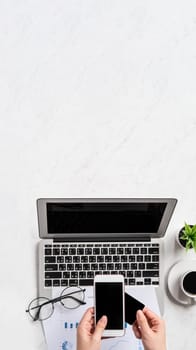 A woman is doing a online payment or shopping, mock up credit card and mobile phone on office desk isolated on beautiful fashion marble background, topview, flatlay, copyspace.