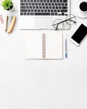 Stylized clean marble office working desk with smartphone, laptop, glasses and coffee, workspace design, mock up, topview, flatlay, copyspace, closeup