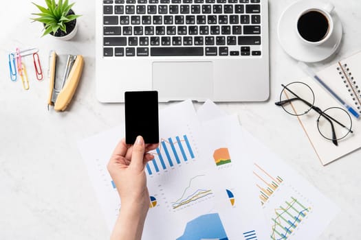 Online bill payment concept, a woman using mock up credit card and mobile cell phone on office desk isolated on beautiful fashion marble background, copy space, topview, flatlay, closeup