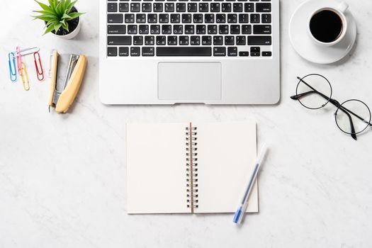 Stylized clean marble office working desk with smartphone, laptop, glasses and coffee, workspace design, mock up, topview, flatlay, copyspace, closeup