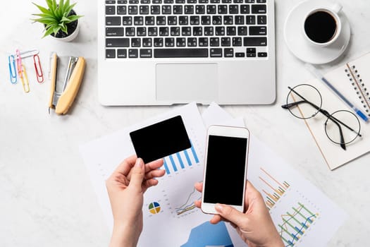 Online bill payment concept, a woman using mock up credit card and mobile cell phone on office desk isolated on beautiful fashion marble background, copy space, topview, flatlay, closeup