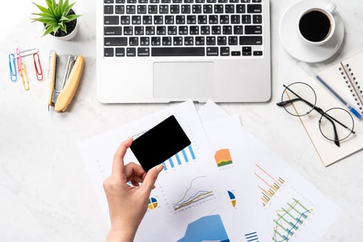 Online bill payment concept, a woman using mock up credit card and mobile cell phone on office desk isolated on beautiful fashion marble background, copy space, topview, flatlay, closeup