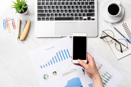 Online bill payment concept, a woman using mock up credit card and mobile cell phone on office desk isolated on beautiful fashion marble background, copy space, topview, flatlay, closeup