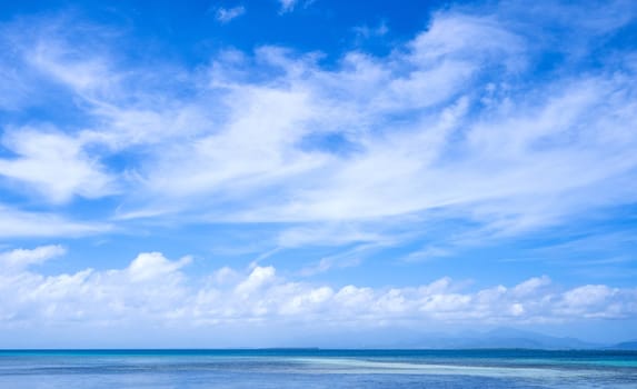 Beautiful ocean scene view isolated with light blue sky background, concept of vacation and sea travel, copy space
