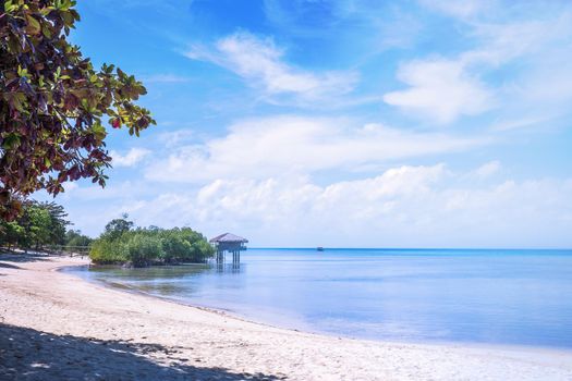 Chairs on the amazing beautiful sandy beach near the ocean with blue sky. Concept of summer leisure calm vacation for a tourism idea. Empty copy space, inspiration of tropical landscape