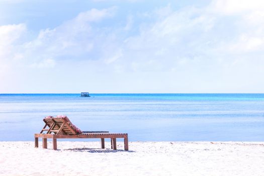 Chairs on the amazing beautiful sandy beach near the ocean with blue sky. Concept of summer leisure calm vacation for a tourism idea. Empty copy space, inspiration of tropical landscape