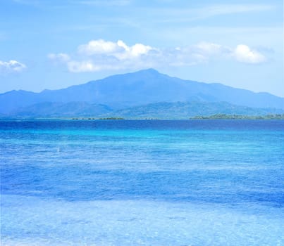 Beautiful ocean scene view isolated with light blue sky background, concept of vacation and sea travel, copy space