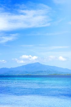 Beautiful ocean scene view isolated with light blue sky background, concept of vacation and sea travel, copy space