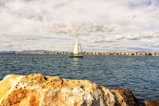 Sailboat entering the port of Santa Pola, Alicante, Spain