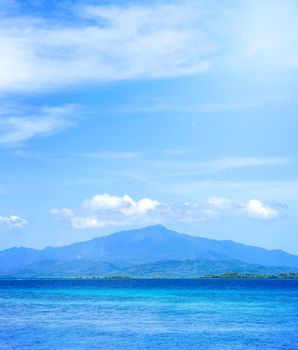 Beautiful ocean scene view isolated with light blue sky background, concept of vacation and sea travel, copy space