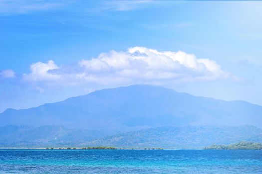 Beautiful ocean scene view isolated with light blue sky background, concept of vacation and sea travel, copy space