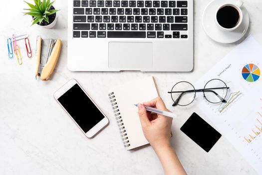 Concept of a woman is doing a accounting, mock up card and cellphone on office desk isolated on beautiful fashion marble background, copy space, top view, flat lay, closeup