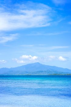 Beautiful ocean scene view isolated with light blue sky background, concept of vacation and sea travel, copy space