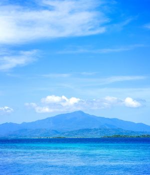 Beautiful ocean scene view isolated with light blue sky background, concept of vacation and sea travel, copy space